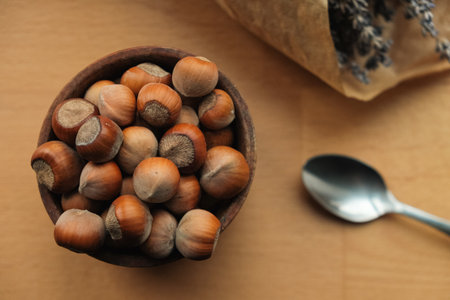 Gathering fresh hazelnuts in a rustic wooden bowl with lavenderの写真素材