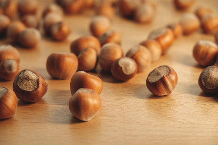 Nuts scattered across a wooden table create a cozy and inviting sceneの写真素材
