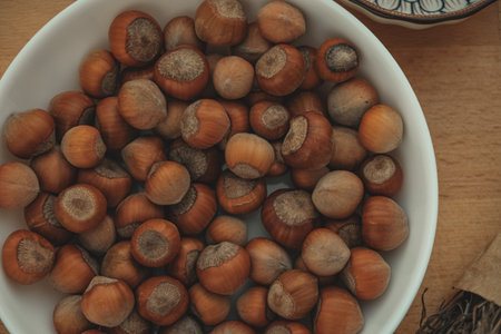 Discovering the beauty and flavor of freshly harvested hazelnuts in a bowlの写真素材