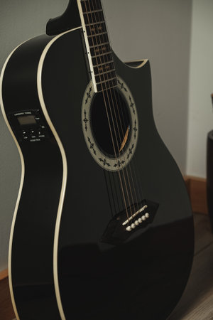 Melodic beauty captured in a sleek black acoustic guitarの写真素材