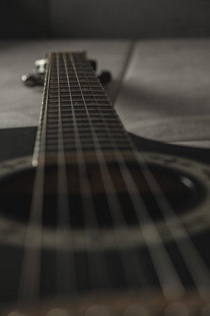 Guitar strings create a melody of shadows and light in an artistic setupの写真素材