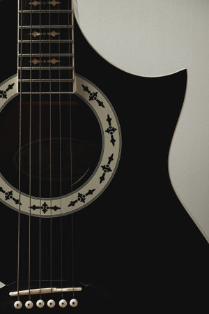 Heartfelt tunes echo from a lovely black guitar on a quiet eveningの写真素材
