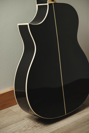 Beautiful black acoustic guitar displaying fine craftsmanship and designの写真素材