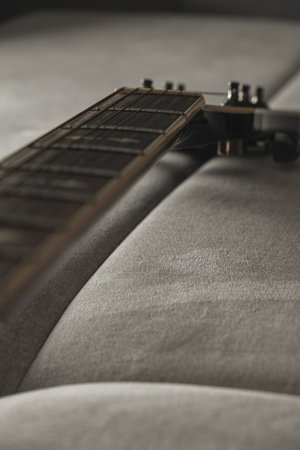 Musical moments captured in a cozy setting with guitar resting on a couchの写真素材