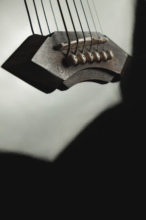 Close-up of a stunning guitar bridge and strings capturing musicの写真素材