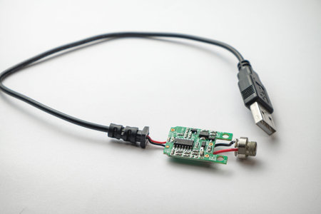 Circuit board connected to USB cable displays intricate technology detail