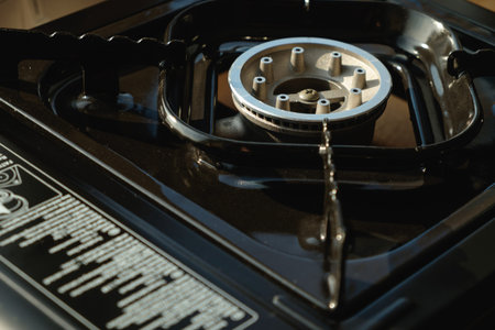 Creating culinary magic with a modern gas stove burner in a cozy kitchenの写真素材