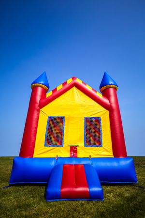 Children's inflatable bouncy castle house in a yard.の素材 [FY31077741957]