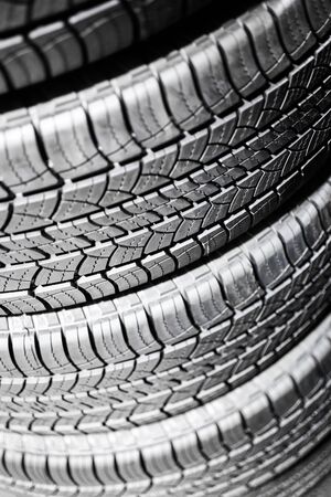 Car tires in a stack at an automotive repair service shopの写真素材