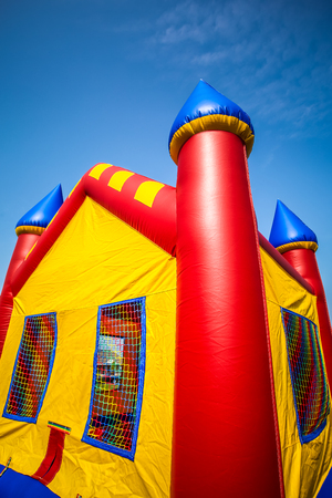 Children's inflatable bouncy castle in red, yellow and blueの写真素材