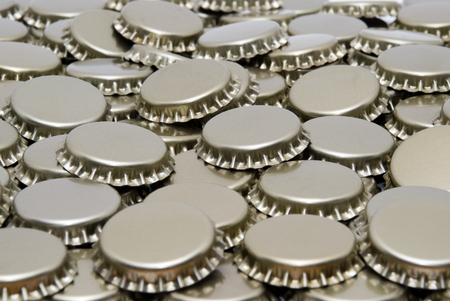 Beer bottle caps in a pile pictureの写真素材