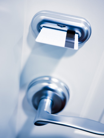 Key card electronic door lock security on a hotel room door.の写真素材