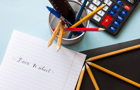Note book, pencils and colorful markers on the table flat layの写真素材