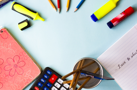 Note book, pencils and colorful markers on the table flat layの写真素材