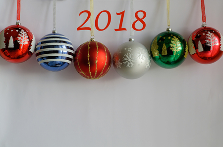colorful, round ornaments on a white background. It's a New Year holiday.Place to write text. Copy...