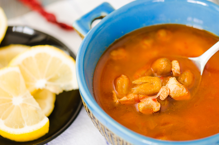 Homemade bombo soup in a blue bowl with on the table.の写真素材