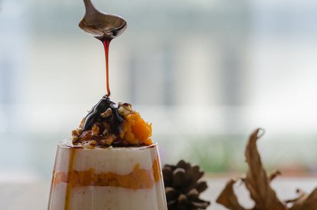 Layered pumpkin dessert with cream and walnut,boiled grape juiceの写真素材