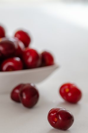 Fresh cherries in bowl on tableの写真素材