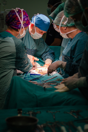 The surgeon is operating carefully and concentrically.の写真素材