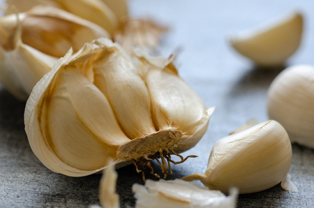 Fresh garlic on wooden table. Peeled garlic bulbs on wooden table.Selective focusの写真素材