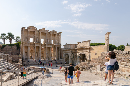 EPHESUS (EFES) ARCHEOLOGÄ°CAL SÄ°TE,TURKEY-AUGUST 19,2018:Tourists explore and photograph Ephesus Archeological Site.The celsus library.のeditorial素材