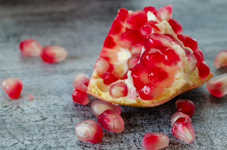 Sliced pomegranate and grains on wooden table,close up,detail,の写真素材