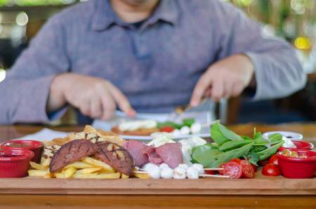 The man is having breakfast with pleasure.Blurred background.の写真素材