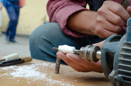 Craftsman is shaping meerschaum.He makes rosary.の写真素材