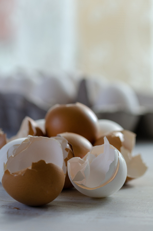 Close up of broken egg shells on wooden background,blurred background.の写真素材