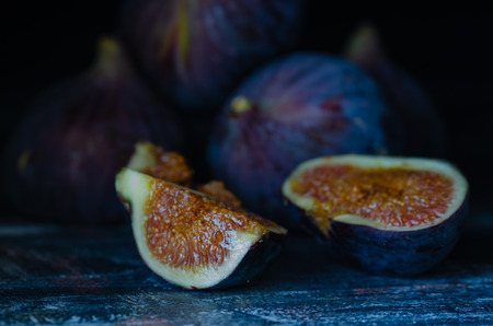 Figs on a dark wood background. selective focus on the figs slice