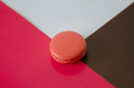 Pink  macaroon on the middle of pink-brown- white triangle.Abstact background.の写真素材