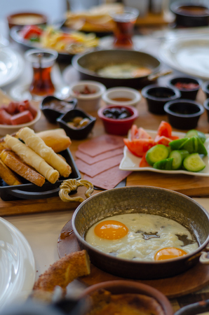 Turkish Breakfast, tomatoes, cucumber, sausage,olive,honey,butter fried egg,turkish tea.の写真素材
