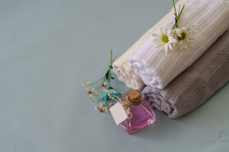 Beautiful flowers with towel and bottles isolated on blue background.の写真素材