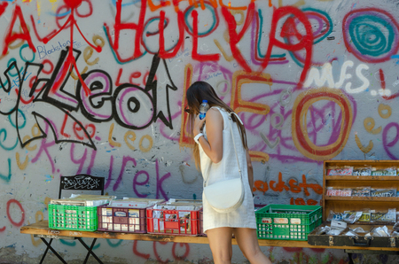 Istanbul,TURKEY-July 22,2017: Karakoy District Istanbul, Turkey.Karakoy is a region where tourists visit.Girl is looking into boxes.のeditorial素材