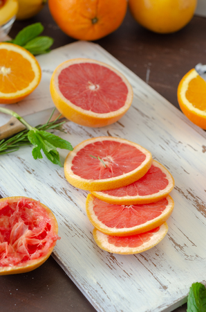 Ripe grapefruit and oranges  on the wooden table,の写真素材