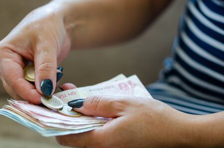 The woman is counting turkish liras