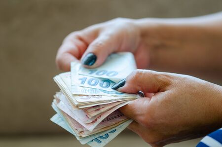 The woman is counting turkish liras banknoteの写真素材
