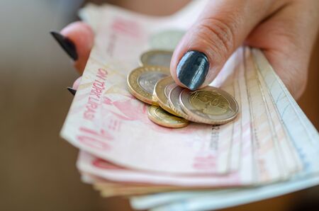 The woman is counting turkish liras