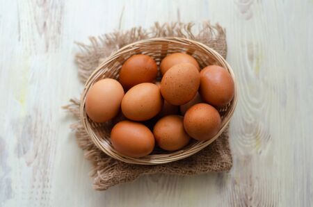 Directly above shot of eggs in basket on wooden tableの写真素材