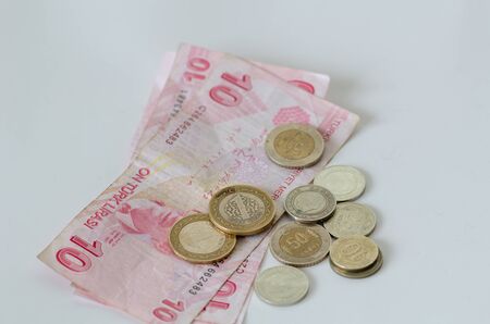 Turkish banknotes and coins are on white background.