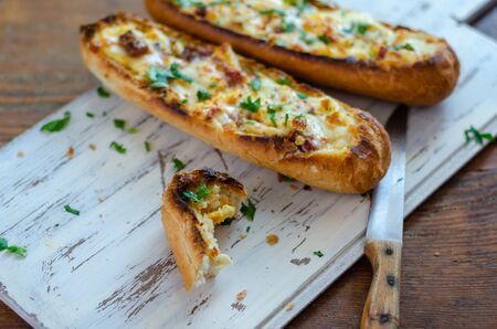 The cheese filled baguette breads on the table in kitchen,close up.