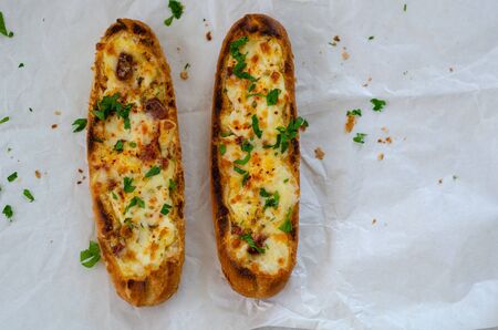 Two baguette breads with cheese filling top view, flat lay.の写真素材