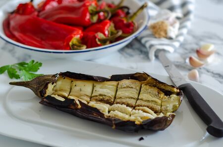 Grilled red peppers and eggplant for vegetable salad on white plate.の写真素材