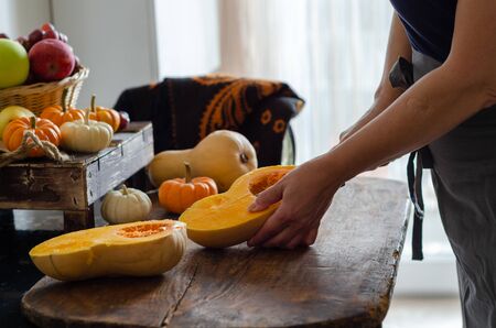 Happy Halloween! Mother is cutting the pumpkin.Mother is  preparing for holiday.の写真素材