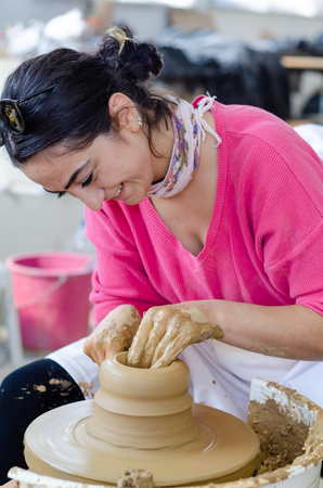 Eskisehir,TURKEY-September 10,2019: 13th.Eskisehir International Terra Cotta Symposium.The artist shows how to make bowl on potters wheelのeditorial素材