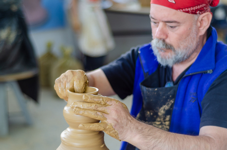 Eskisehir,TURKEY-September 08,2019: 13th.Eskisehir International Terra Cotta Symposium.The artist shows how to make bowl on potters wheelのeditorial素材