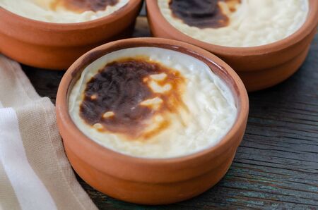 Turkish rice pudding sutlac, turkish dessert on wooden table.の写真素材