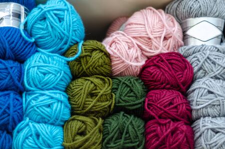 Colorful wool balls on shelf compartment in haberdashery