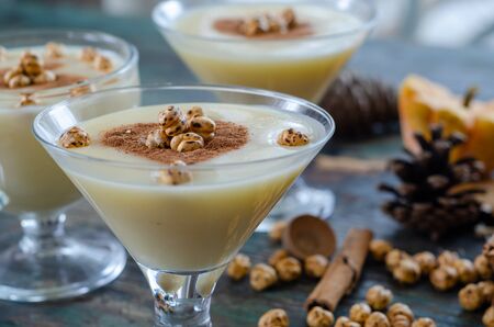 Traditional turkish drink; boza with cinnamon sticks and chickpea on the table.