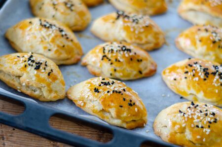 Homemade  cheesy pastry on the tray in the kitchen.の写真素材